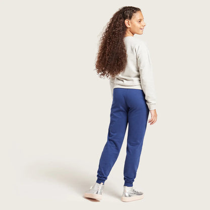 Kids blue jogger pants with elastic waistband, drawstring, and cuffed ankle hems