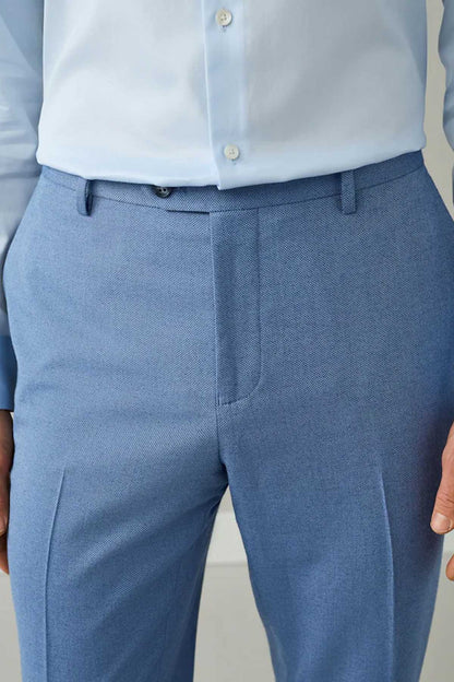 Men's chambray blue suit trousers close-up of waistband with belt loops