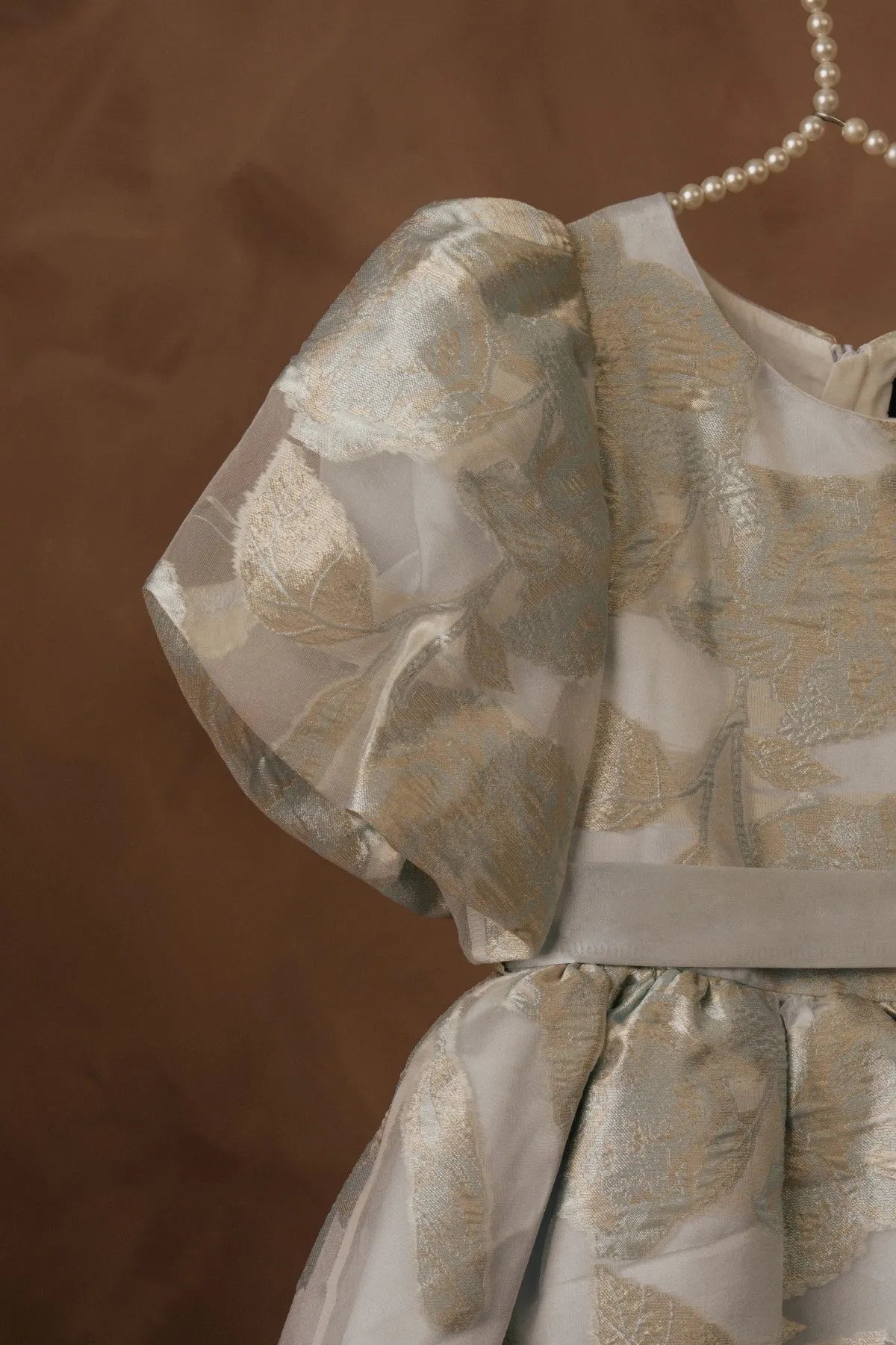 Licci girls cream dress with gold animal print, puff sleeves and pearl hanger