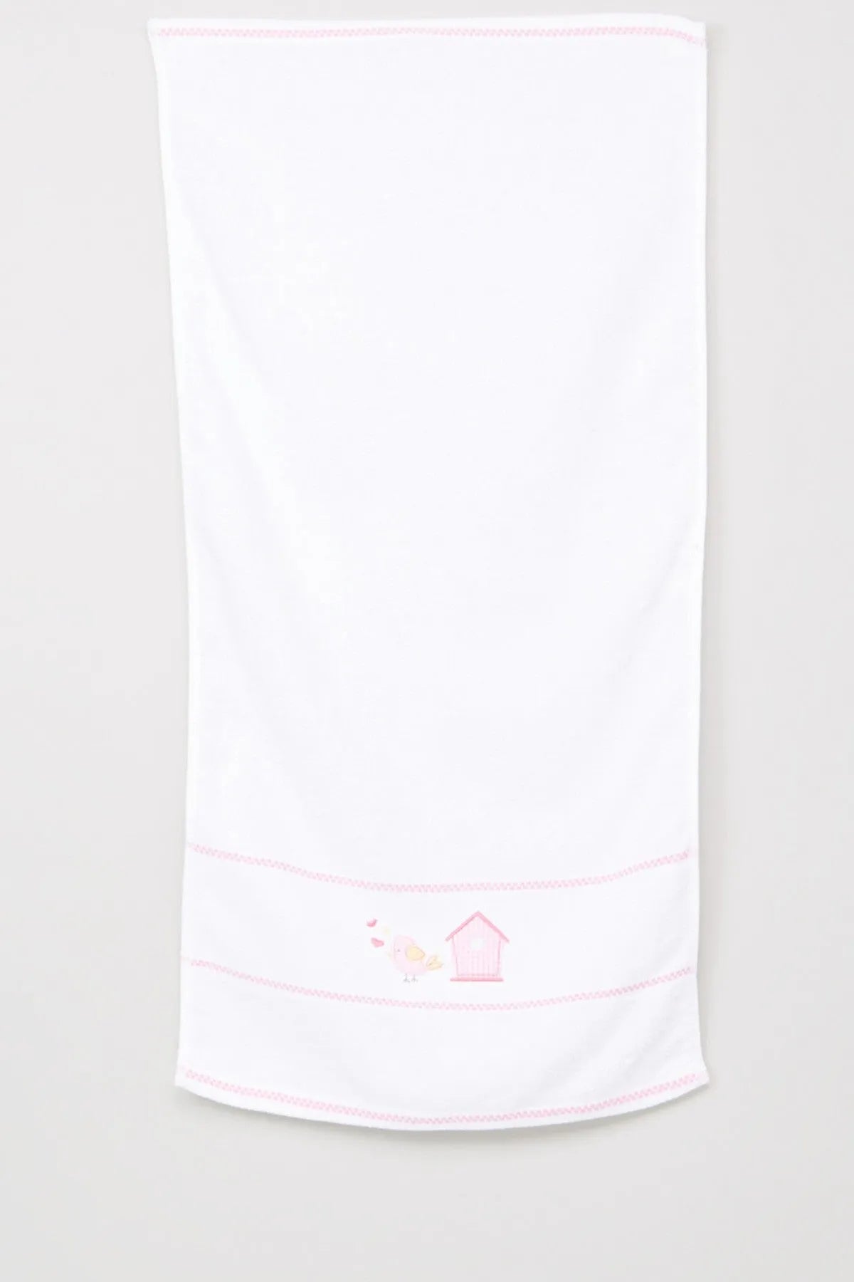 White baby blanket with pink edge trim and stitched house-and-bunny motif