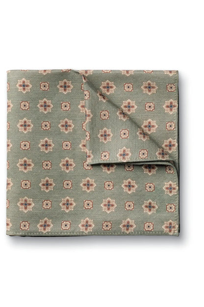 Green printed pocket square with small floral medallions and pink accents