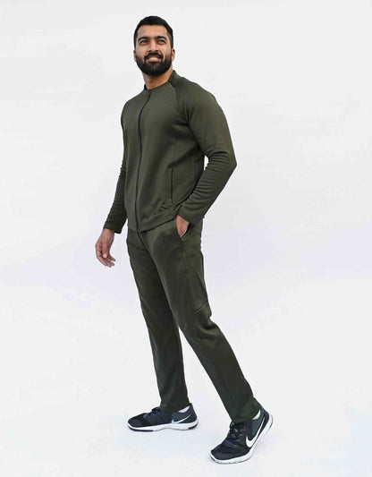 Bodybrics dark olive jogger pants on model, tapered legs and drawstring waist
