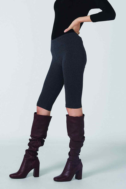Dark gray capri leggings with a cropped hem and black turtleneck top