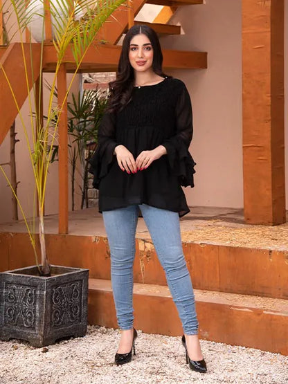 Black long-sleeve tunic with gathered yoke, ruffled cuffs, and flowing layered hem