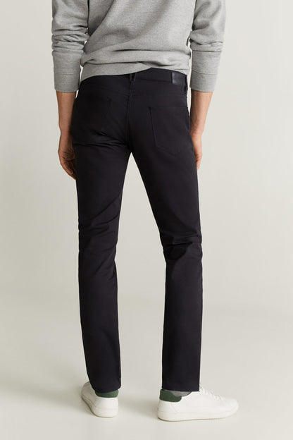 Black slim pants, back view, with belt loops and straight leg.