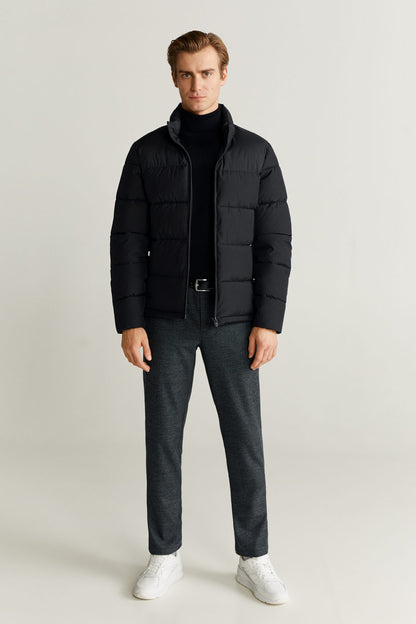Dark gray textured trousers with belt loops, zip fly, and button closure.