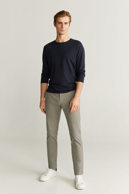 Light grey straight trousers with cuffed hem and side pockets.