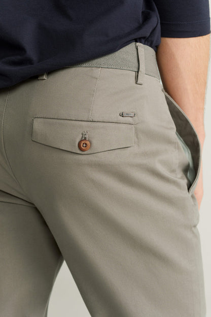 Grey trousers with button closure, belt loops, and front flap pocket detail.