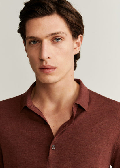Close-up of burnt orange polo collar with button placket and knit texture