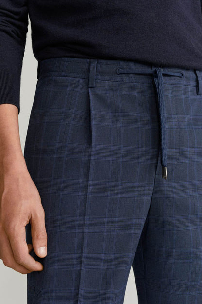 Men's dark navy plaid trousers close-up: waistband, belt loops, drawstring