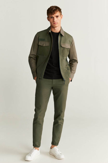 Khaki tapered pants with button fly, side pockets, and ankle cuff hems