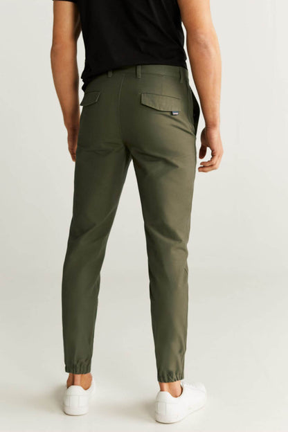 Khaki slim-fit trousers with tapered fit, ankle cuffs, and side pockets