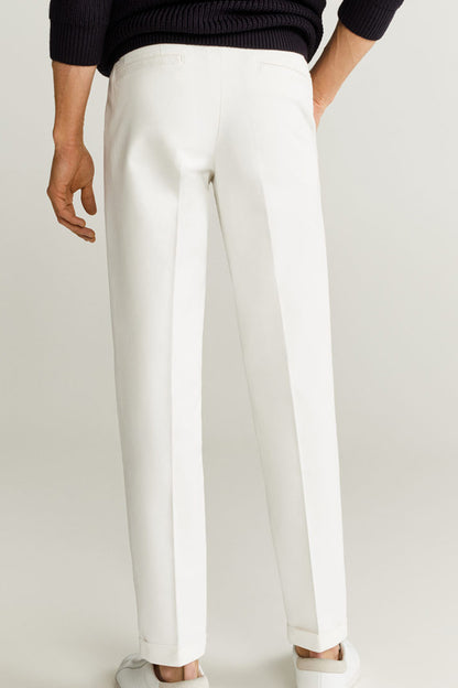 White trousers with tapered legs and front crease details