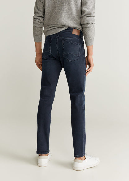 Dark blue slim-fit jeans with cuffed hem and stitched pockets