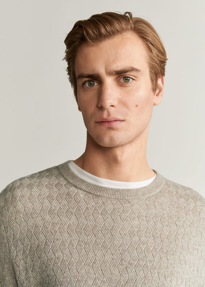 Beige textured knit crewneck sweater with detailed stitch pattern