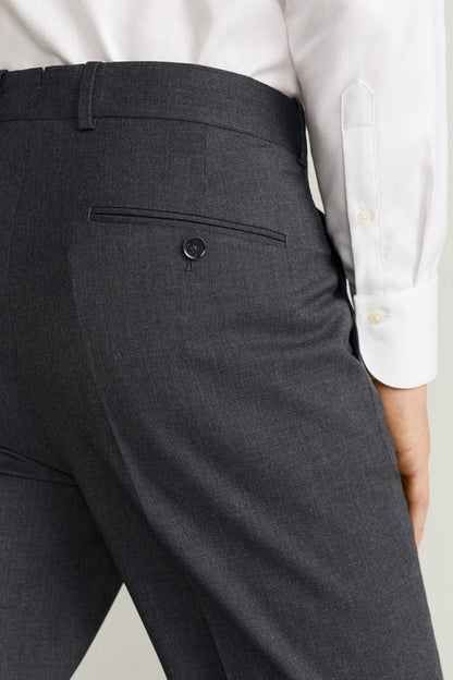 Men's dark grey dress trousers front pocket with button closure detail
