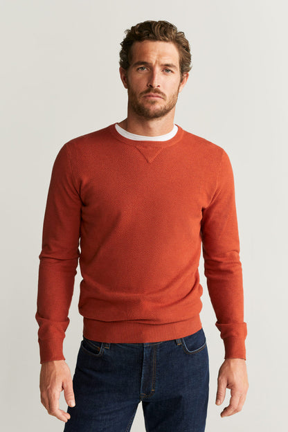 Men's rust-orange crewneck sweater with long sleeves and ribbed hem and cuffs
