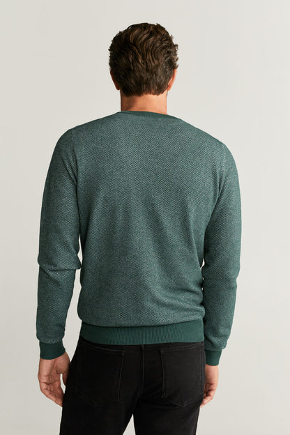 Back view of green crewneck knit sweater with ribbed cuffs and hem
