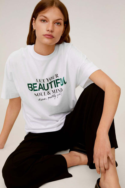 White crew-neck graphic T-shirt with green slogan text