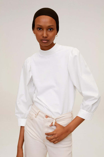 MANGO off-white long-sleeve blouse with high collar and high-waist jeans