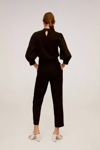 Black high-neck jumpsuit, back view with long puff sleeves and ankle-length legs