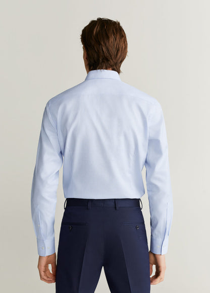 Light blue men's dress shirt back view with yoke seams and long sleeves