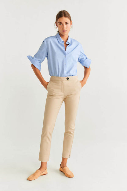Beige slim trousers with button waist, belt loops and pressed front creases