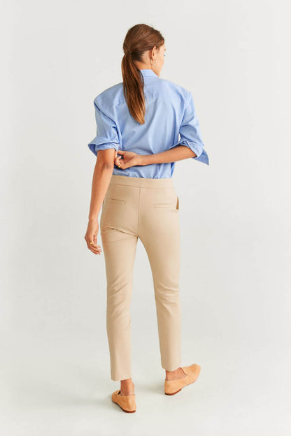 Beige slim trousers with button waist, belt loops and ankle-length straight legs