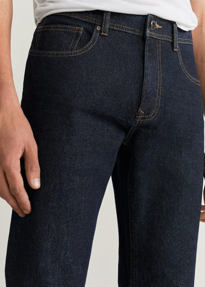 Dark blue denim jeans close-up: belt loops, button closure, and coin pocket