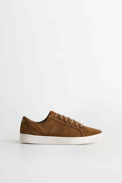 Brown suede low-top sneakers with lace-up front and white rubber sole