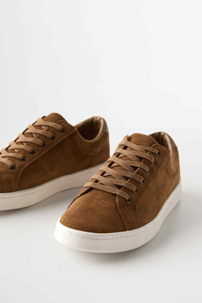 Brown suede low-profile sneakers with tan laces and white rubber sole