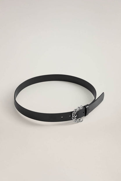 Black leather belt with silver chain centerpiece buckle, laid flat