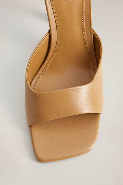 Brown leather-look mules with stitched footbed and open toe platform