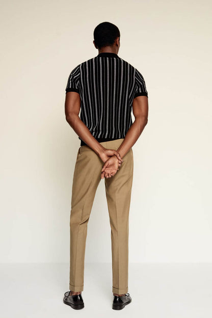 Tan chino trousers with belt loops and straight tapered legs, back view