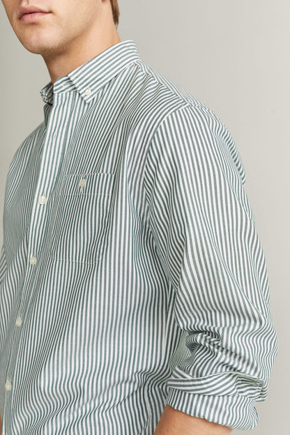 Striped button-up shirt side view with long cuffed sleeve and chest pocket, light blue and white