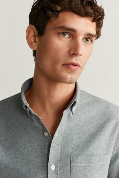 Men's gray button-up shirt close-up of collar and front buttons