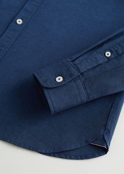 Dark navy button-up shirt sleeve cuff and button placket detail