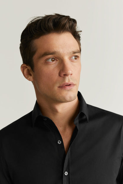 Close-up of men's black button-up shirt collar and top button