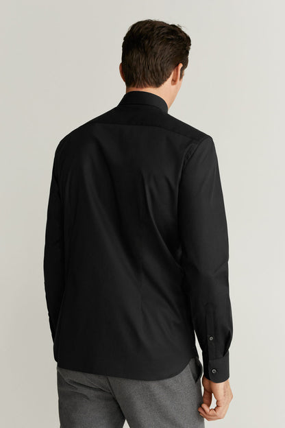 Back view of men's black button-up shirt with collar and button cuffs