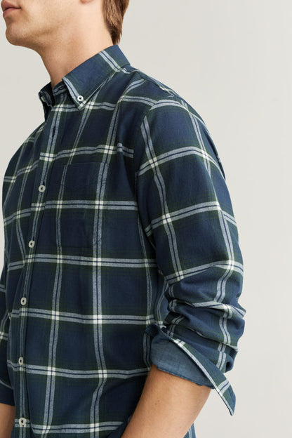 Men's navy plaid button-up shirt with rolled cuffs, side view