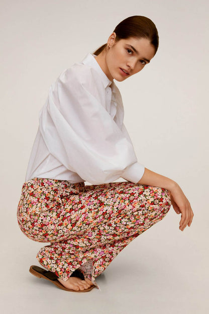 Floral print wide-leg trousers with elastic waist, side view while kneeling
