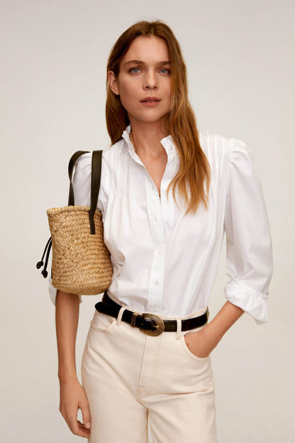 Off-white blouse with button placket, ruffled collar, and gathered cuffs