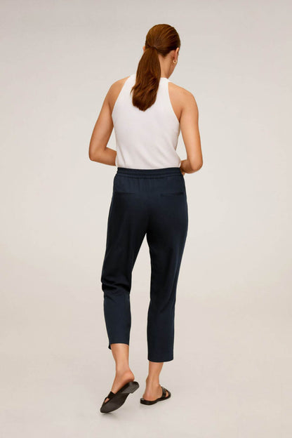 Navy cropped jogger pants, drawstring waist and tapered legs (back view)