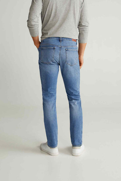 Men's medium-blue jeans with straight fit, back yoke, and belt loops