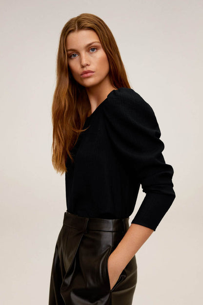 Black blouse with long puff sleeves and round neck, side view