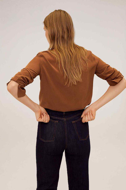 Brown blouse back view with collar and three-quarter sleeves, hands on hips