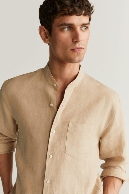 Beige linen button-up shirt close-up: mandarin collar and chest pocket