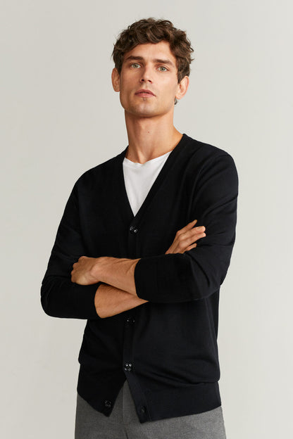 Black V-neck cardigan with button front, long sleeves, arms crossed