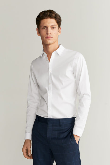 White dress shirt with button front, buttoned cuffs, spread collar