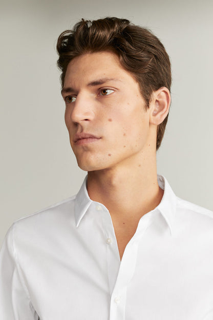 White dress shirt close-up of collar and button placket, long sleeves